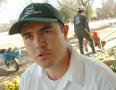 Primary view of [Close-up of man in green hat]