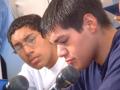 Primary view of [Two young men speaking into microphone]
