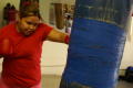 Primary view of [Girl in red shirt hitting heavy bag]