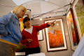 Primary view of [Two women looking at artwork, one pointing with her left hand]
