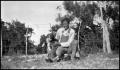 Photograph: [Photograph of a Man Kneeling with a Dog]