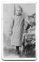 Photograph: [Unidentified child standing beside armchair]