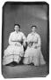 Primary view of [Two seated women in tiered dresses]