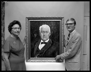 Primary view of object titled '[Johnnie Bell McDonald Ballard and Carl Avera beside painting of John H. Reagan]'.