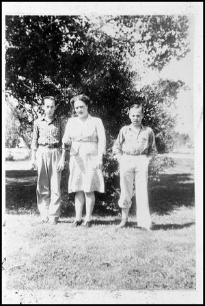 Primary view of object titled '[Three People Standing Outdoors]'.