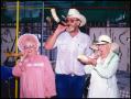 Primary view of [Man and Two Women Blowing Horns]