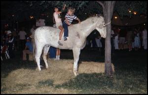 Primary view of object titled '[Children Riding Artificial Horse in Frontier Playland]'.