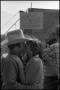 Photograph: [Man Kissing Woman in Free Cowboy Kisses Booth]