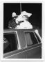 Photograph: [Two People Standing Through a Limousine Roof]