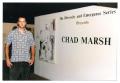 Photograph: [Chad Marsh in Front of a Title Wall]