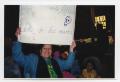 Thumbnail image of item number 1 in: '[Woman with Sign at Day of the Dead Parade]'.