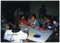 Photograph: [Boys and Girls Eating Pizza During Field Trip]
