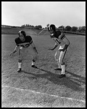 Primary view of object titled '[Two Football Players Standing in Athletic Stances]'.