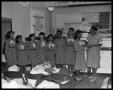 Photograph: [Girl Scouts Standing at a Demonstration Kitchen]