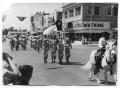 Photograph: [Colonel Sam Privitt on Caesar with Military Color Guard and Band]