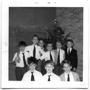 Primary view of object titled 'Group of school boys standing in the corner of a classroom'.