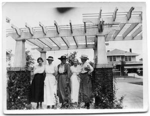 Primary view of object titled 'Five women standing under a gazebo.'.