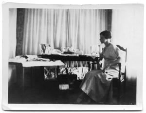 Primary view of object titled 'Cora Lee Vise sitting at a table'.