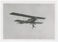 Photograph: [Ormer Locklear hanging upside down from biplane]