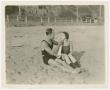 Primary view of [Ormer Locklear and Viola Dana sitting on the beach]