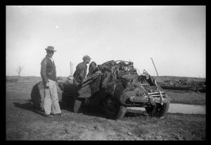 Primary view of object titled '[Photograph of Two Men and Tornado-Damaged Truck]'.