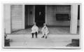 Photograph: Two Children Sitting on a Porch
