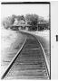 Photograph: Curved track leading to a railroad station