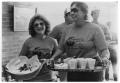Photograph: Two women with serving trays at a Gumbo Cookoff