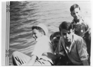 Primary view of object titled 'Four boys in a boat on the water'.