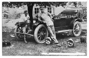 Primary view of object titled '[E.W. Brown and Calvin Stakes work on an Automobile]'.