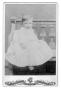 Photograph: [Unknown infant in white dress]