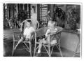 Photograph: [Two children seated on a porch]