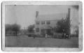 Photograph: Two Story White Frame House and People