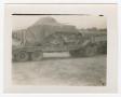Photograph: [Photograph of Covered Locomotive on Truck Bed]