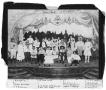 Photograph: Group in costume posed on stage at Old Evans Hall--2nd and Houston