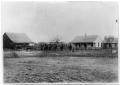 Photograph: Men on horses in front of a ranch house, Sweetwater, Texas, 1883