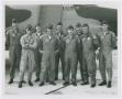 Photograph: [Men Standing in Front of Plane]