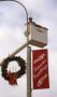 Photograph: [Seasons greetings sign on lamppost in Denton, Texas]