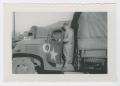 Photograph: [Soldier Standing on Truck]