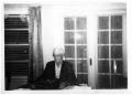 Primary view of [Wayne Cartledge sitting at a typewriter]