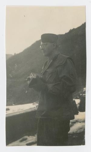 Primary view of object titled '[Soldier Holding Radio Device]'.