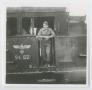 Photograph: [Soldier Standing in a Railroad Car Entryway]