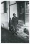 Photograph: [Cecil Couts Standing near a House]