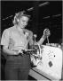 Thumbnail image of item number 1 in: 'Ida Stephensen operating a Tube-bending Machine'.