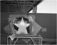 Photograph: [Painting a star on a US special transport plane]