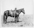 Photograph: Cowboy with Saddled Horse