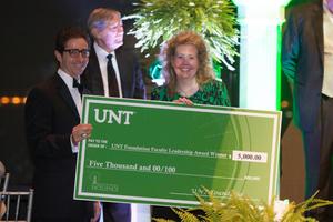 Primary view of object titled '[Angela Wilson with check at Salute to Faculty Excellence event]'.