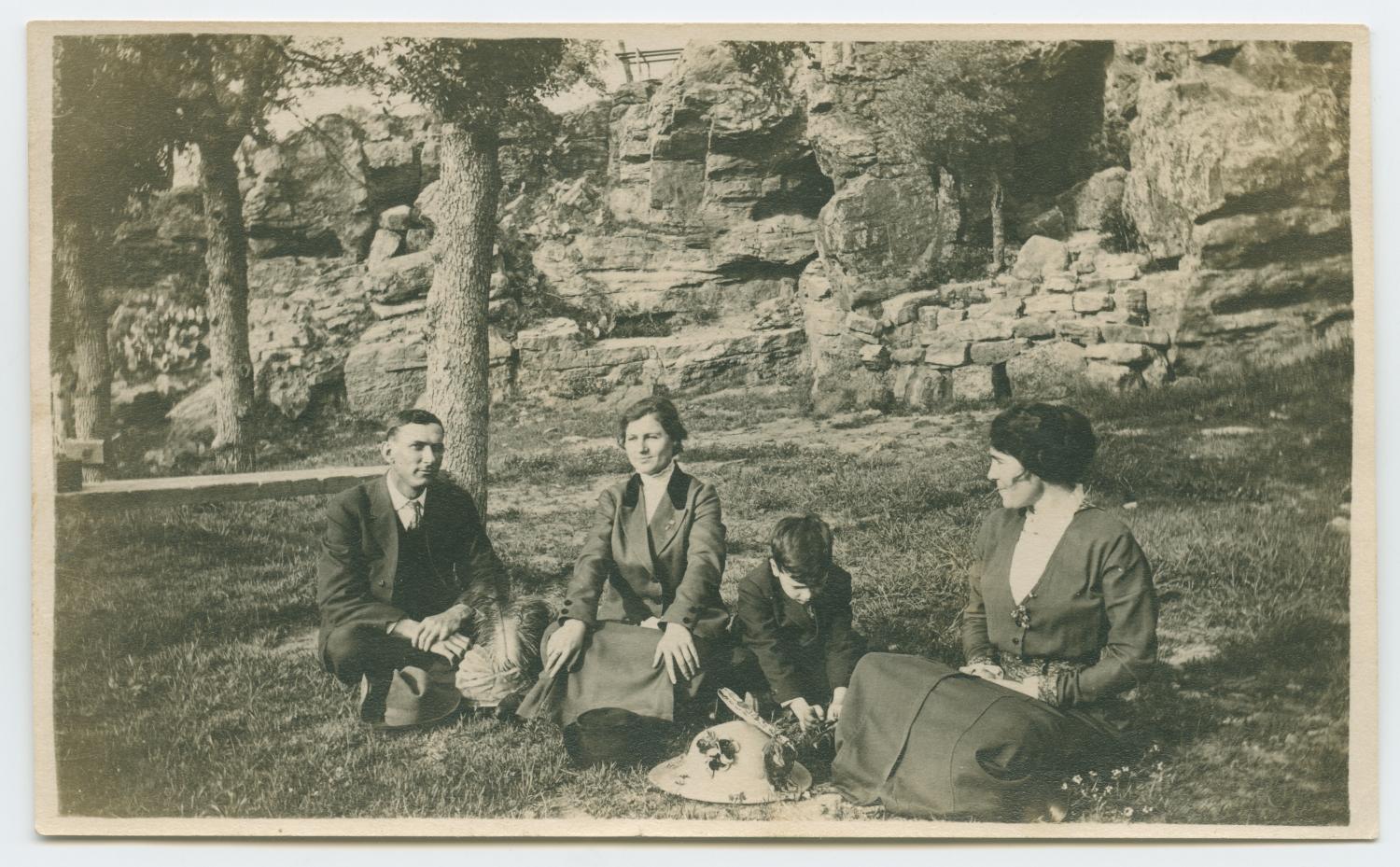 [Photograph of People Sitting by a Rock Slope]
                                                
                                                    [Sequence #]: 1 of 2
                                                