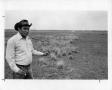 Primary view of [Photograph of a Man Standing by Smutgrass]
