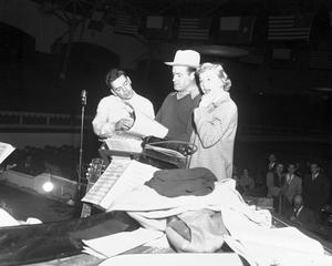 Primary view of object titled '[Bob Hope, Doris Day, and Les Brown prepare for a show in Cowtown Coliseum]'.